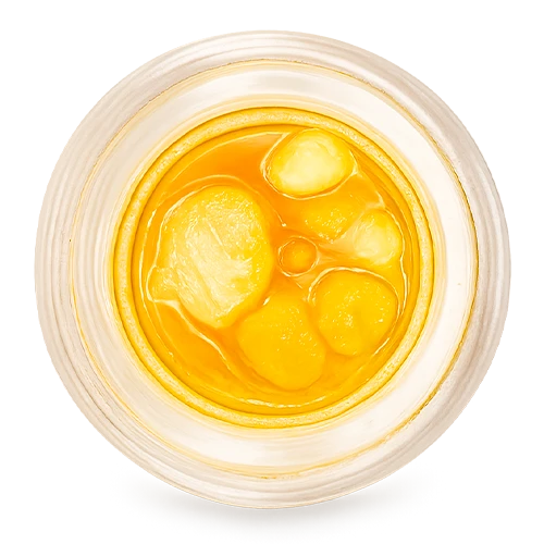 Top-down view of Bedford Grow cannabis concentrate featuring bright golden diamonds and sauce inside a clear glass jar.